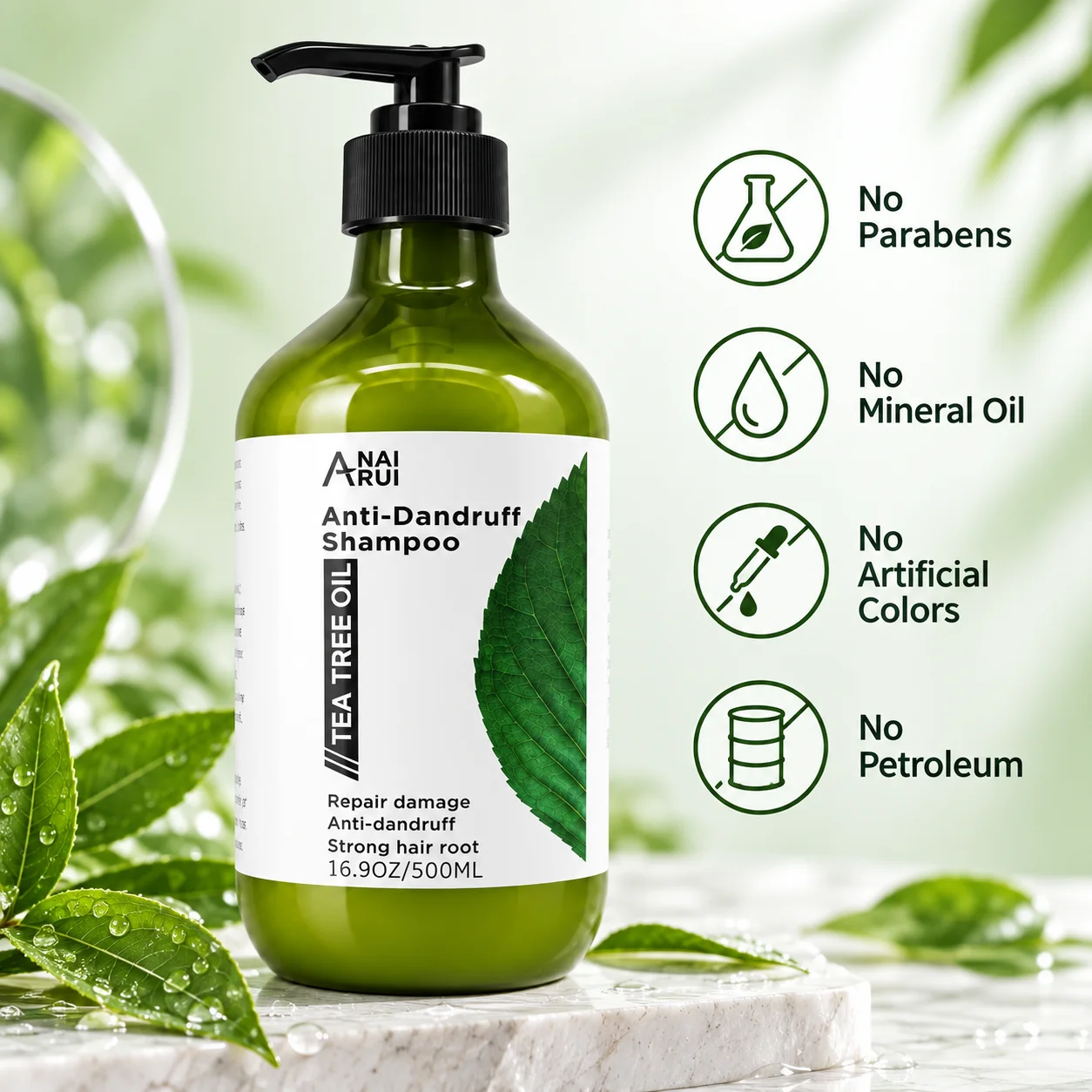 Green bottle of tea tree oil anti-dandruff shampoo on a marble surface with fresh leaves and product attributes, highlighting no parabens, mineral oil, artificial colors, or petroleum.